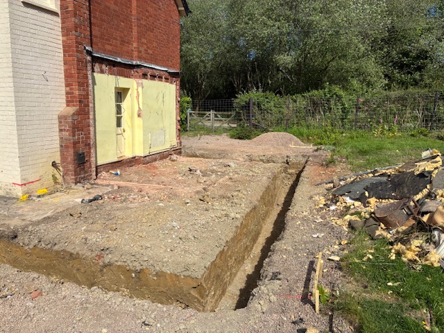 Foundation trench excavated alongside a house