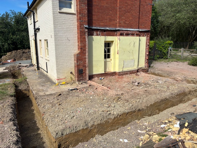 Excavated footings running along the side of a property