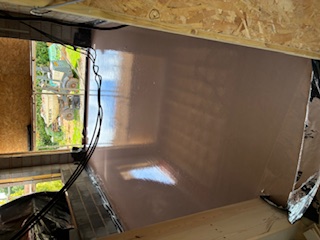 Freshly poured liquid screed with a smooth, level finish