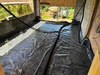 Tanking membrane and underfloor heating set out before pouring screed